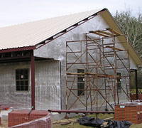 Foil insulation is installed between brick exterior and steel framing